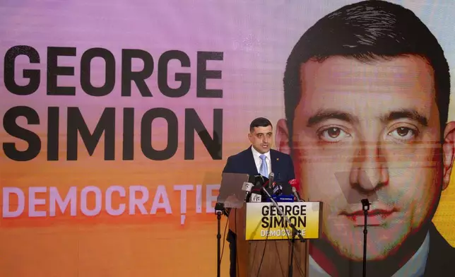 George Simion, the leader of Romania's most popular far-right party, the Alliance for the Union of Romanians (AUR), speaks in Bucharest, Romania, Friday, March 14, 2025, after filing his candidacy to participate in the country's presidential election rerun in May as he seeks to rally nationalist voters in the wake of last year's controversial frontrunner being barred from the race. (AP Photo/Vadim Ghirda)