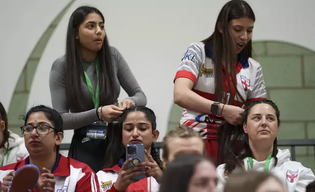 England players have their hair platted before their semifinal match against Wales at the Kabaddi World Cup in Walsall, England, Friday, March 21, 2025.(AP Photo/Jon Super)