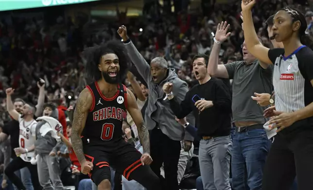 Chicago Bulls' Coby White (0) celebrates after making a three-point basket during the final seconds of an NBA basketball game against the Los Angeles Lakers Thursday, March 27, 2025, in Chicago. (AP Photo/Paul Beaty)