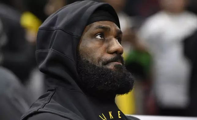 Los Angeles Lakers' LeBron James looks on from the bench before an NBA basketball game against the Chicago Bulls, Thursday, March 27, 2025, in Chicago. (AP Photo/Paul Beaty)