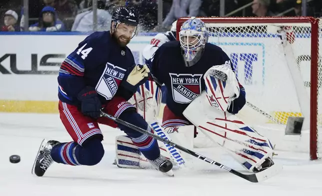 New York Rangers' Calvin de Haan (44) and goaltender Igor Shesterkin (31) stops a shot during the second period of an NHL hockey game against the Washington Capitals Wednesday, March 5, 2025, in New York. (AP Photo/Frank Franklin II)