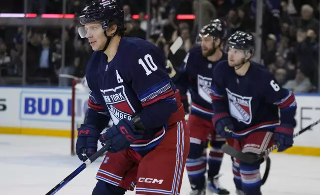 New York Rangers' Artemi Panarin (10) leads teammates toward their bench after Panarin scored a goal during the first period of an NHL hockey game against the Washington Capitals Wednesday, March 5, 2025, in New York. (AP Photo/Frank Franklin II)