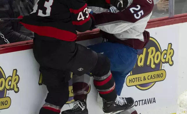 Ottawa Senators defenseman Tyler Kleven, left, collides with Colorado Avalanche right wing Logan O'Connor, right, behind the net during second-period NHL hockey game action, Thursday, March 20, 2025, in Ottawa, Ontario. (Adrian Wyld/The Canadian Press via AP)