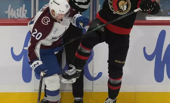 Colorado Avalanche center Ross Colton (20) collides with Ottawa Senators defenseman Artem Zub, right, during first-period NHL hockey game action, Thursday, March 20, 2025, in Ottawa, Ontario. (Adrian Wyld/The Canadian Press via AP)