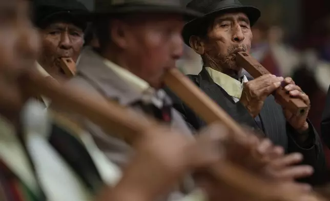 Musicians play Andean flutes during a competition to elect representatives for three Carnival characters — Chuta, Pepino and Chola — in El Alto, Bolivia, Wednesday, Feb. 19, 2025. (AP Photo/Juan Karita)
