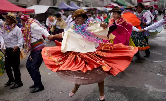 Revelers dance during the "Jisk'a Anata," or small party in Aymara, in La Paz, Bolivia, Monday, March 3, 2025. (AP Photo/Juan Karita)