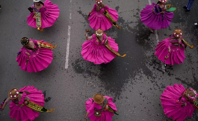 Revelers dance during an Andean Carnival celebration in El Alto, Bolivia, Saturday, March 1, 2025. (AP Photo/Juan Karita)