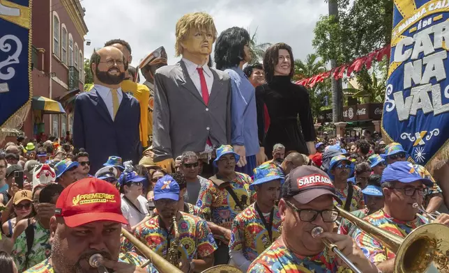 A large puppet of U.S. President Donald Trump is paraded during Carnival celebrations alongside other puppets of local politicians and artists in Olinda, Pernambuco state, Brazil, Monday, March 3, 2025. (AP Photo/Andre Mantelli)