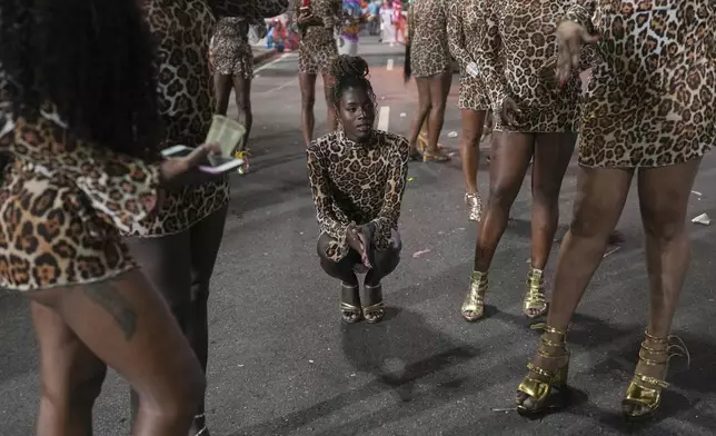 Transgender women with the Paraiso de Tuiuti samba school wait for a rehearsal for the Carnival parade in Rio de Janeiro, Saturday, Feb. 22, 2025. (AP Photo/Silvia Izquierdo)