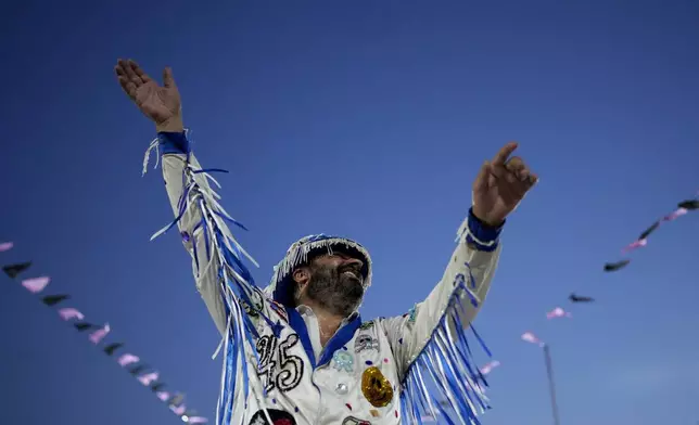 A member of the "Ilusiones de Palermo" group performs during Carnival celebrations in Buenos Aires, Argentina, Tuesday, March 4, 2025. (AP Photo/Natacha Pisarenko)