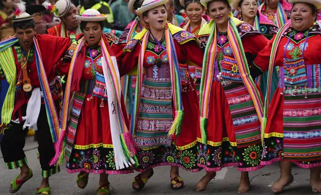 Revelers dance during the "Jisk'a Anata," or small party in Aymara, in La Paz, Bolivia, Monday, March 3, 2025. (AP Photo/Juan Karita)