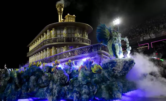 Performers from the Vila Isabel samba school dance during Carnival celebrations at the Sambadrome in Rio de Janeiro, early Tuesday, March 4, 2025. (AP Photo/Bruna Prado)