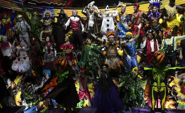 Performers from the Vila Isabel samba school dance during Carnival celebrations at the Sambadrome in Rio de Janeiro, early Tuesday, March 4, 2025. (AP Photo/Bruna Prado)