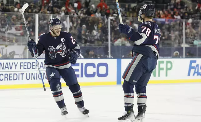 Columbus Blue Jackets' Mathieu Olivier, left, celebrates his goal against the Detroit Red Wings with teammate Damon Severson during the second period of the Stadium Series NHL hockey game at Ohio Stadium Saturday, March 1, 2025, in Columbus, Ohio. (AP Photo/Jay LaPrete)