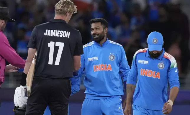 India's Hardik Pandya, centre, shakes hand with New Zealand's Kyle Jamiesond after they won the ICC Champions Trophy cricket match against New Zealand at Dubai International Cricket Stadium in Dubai, United Arab Emirates, Sunday, March 2, 2025. (AP Photo/Altaf Qadri )