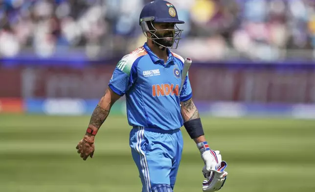 India's Virat Kohli walks off the field after losing his wicket during the ICC Champions Trophy cricket match between India and New Zealand at Dubai International Cricket Stadium in Dubai, United Arab Emirates, Sunday, March 2, 2025. (AP Photo/Altaf Qadri)