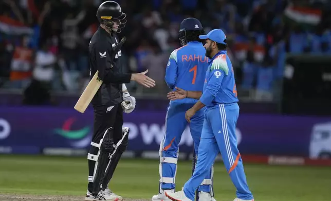 India's captain Rohit Sharma, right, shakes hand with New Zealand's Will O'Rourke after they won the ICC Champions Trophy cricket match against New Zealand at Dubai International Cricket Stadium in Dubai, United Arab Emirates, Sunday, March 2, 2025. (AP Photo/Altaf Qadri )