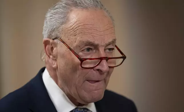 Senate Minority Leader Chuck Schumer, D-N.Y., gives a television interview, as the Senate works to avert a partial government shutdown ahead of the midnight deadline, at the Capitol in Washington, Friday, March 14, 2025. (AP Photo/Ben Curtis)