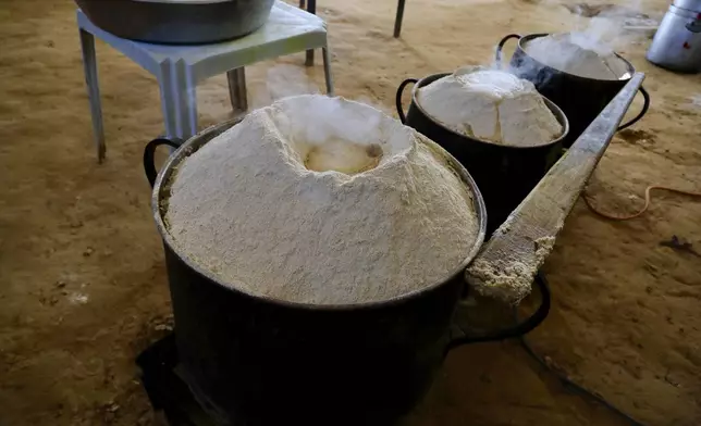 Wheat to prepare Bazin, a traditional Libyan dough bread made of barley or whole wheat flour and often served with stew in Tajoura, east of Libya's capital Tripoli, Tuesday, March 11, 2025, during the Muslim holy month of Ramadan. (AP Photo/Yousef Murad)