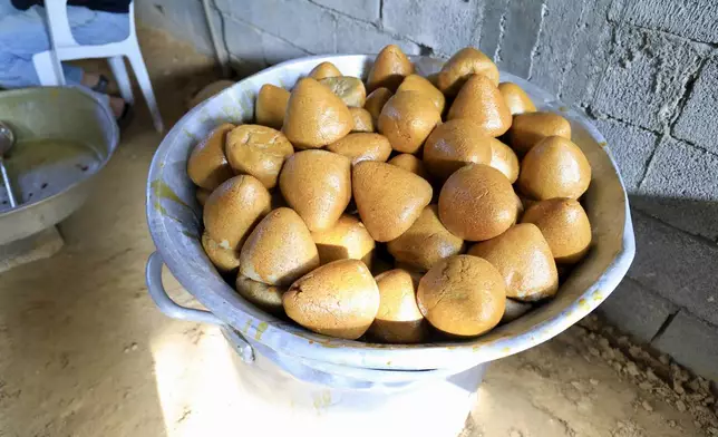 Volunteers serve traditional unleavened Libyan bread made out of barley in Tajoura, east of Libya's capital Tripoli, Tuesday, March 11, 2025, during the Muslim holy month of Ramadan. (AP Photo/Yousef Murad)