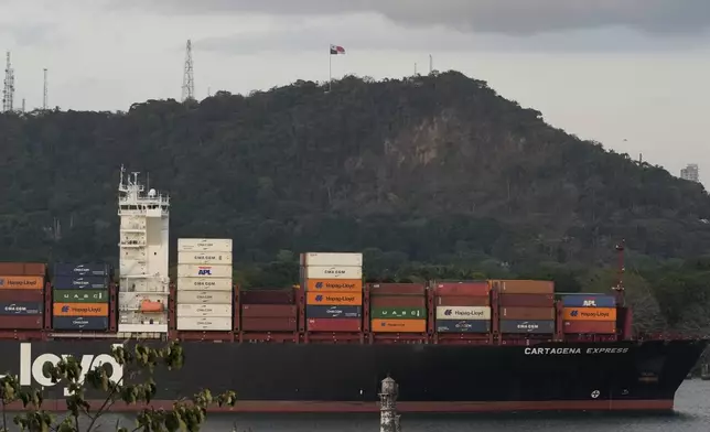A cargo ship sails past the Panama Canal's Port of Balboa in Panama City, Thursday, March 13, 2025. (AP Photo/Matias Delacroix)