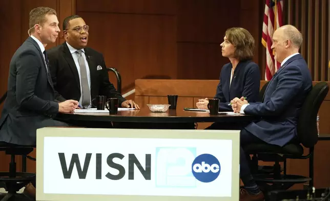 Wisconsin Supreme Court candidates Brad Schimel and Susan Crawford participate in a debate Wednesday, March 12, 2025, in Milwaukee. (AP Photo/Morry Gash)
