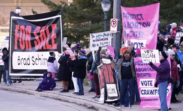 Protesters gather outside the Marquette Lubar Center before a Wisconsin Supreme Court debate between candidates Brad Schimel and Susan Crawford Wednesday, March 12, 2025, in Milwaukee. (AP Photo/Morry Gash)
