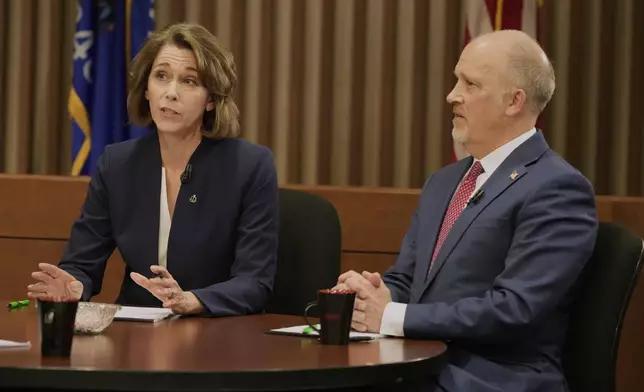 Wisconsin Supreme Court candidates Brad Schimel and Susan Crawford participate in a debate Wednesday, March 12, 2025, in Milwaukee. (AP Photo/Morry Gash)