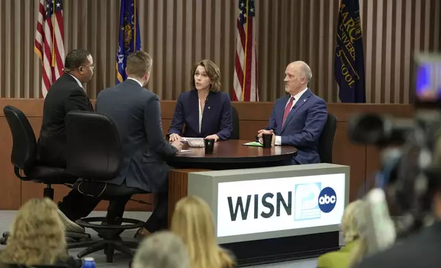 Wisconsin Supreme Court candidates Brad Schimel and Susan Crawford participate in a debate Wednesday, March 12, 2025, in Milwaukee. (AP Photo/Morry Gash)