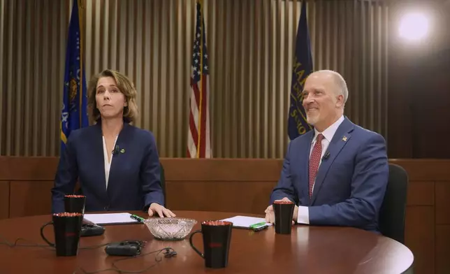 Wisconsin Supreme Court candidates Brad Schimel and Susan Crawford are seen before a debate Wednesday, March 12, 2025, in Milwaukee. (AP Photo/Morry Gash)