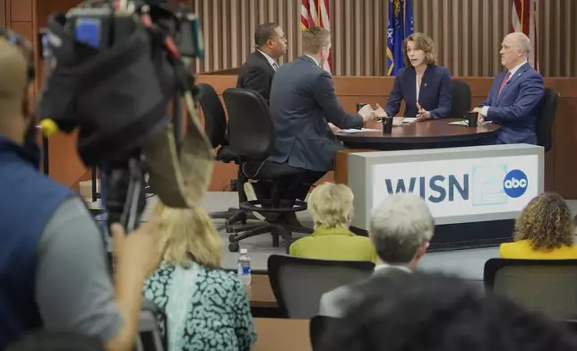 Wisconsin Supreme Court candidates Brad Schimel and Susan Crawford participate in a debate Wednesday, March 12, 2025, in Milwaukee. (AP Photo/Morry Gash)