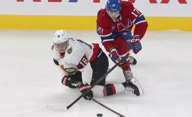 Ottawa Senators' Tim Stutzle (18) and Montreal Canadiens' Josh Anderson (17) battle for the puck during second period NHL hockey action in Montreal on Tuesday, March 18, 2025. (Christinne Muschi/The Canadian Press via AP)