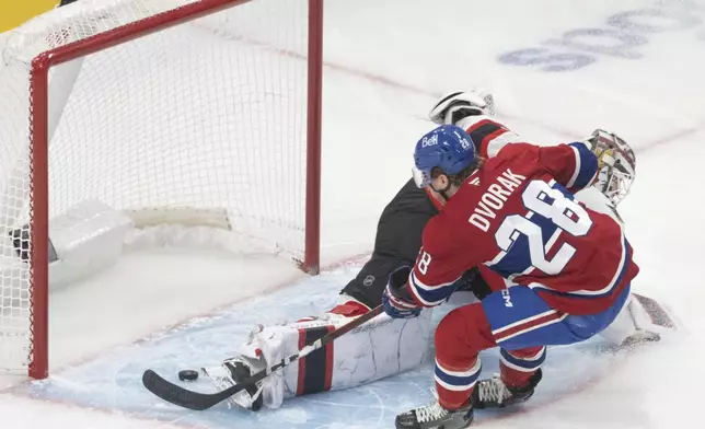 Montreal Canadiens' Christian Dvorak (28) scores on Ottawa Senators goaltender Linus Ullmark (35) during first period NHL hockey action in Montreal on Tuesday, March 18, 2025. (Christinne Muschi/The Canadian Press via AP)