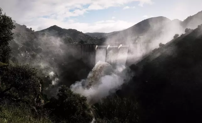 Water is released from the dam of Casasola in Malaga, Spain, Tuesday, March 18, 2025. (AP Photo/Gregorio Marrero)