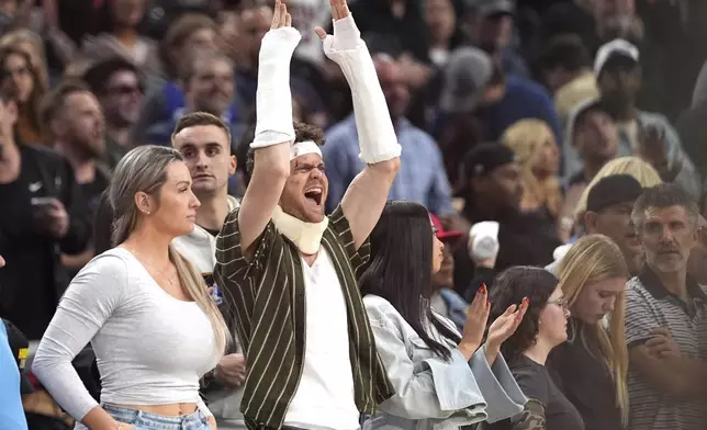 Actor Jack Quaid gestures during the second half of an NBA basketball game between the Los Angeles Clippers and the Sacramento Kings, Sunday, March 9, 2025, in Inglewood, Calif. Quaid was made up to look like he was injured to promote his new film Novocaine. (AP Photo/Mark J. Terrill)