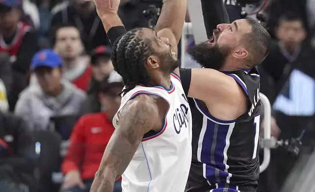 Los Angeles Clippers forward Kawhi Leonard, left, blocks the shot of Sacramento Kings center Jonas Valanciunas during the second half of an NBA basketball game Sunday, March 9, 2025, in Inglewood, Calif. (AP Photo/Mark J. Terrill)