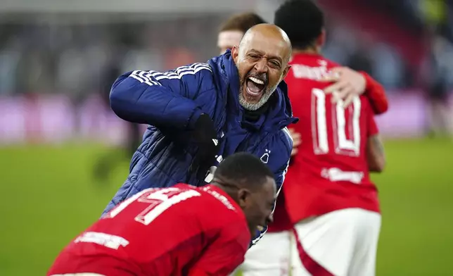 Nottingham Forest manager Nuno Espirito Santo, top, celebrates after winning the penalty shootout during the English FA Cup fifth soccer round match between Nottingham Forest and Ipswich Town at the City Ground, Nottingham, England, Monday, March 3, 2025. (Mike Egerton/PA via AP)