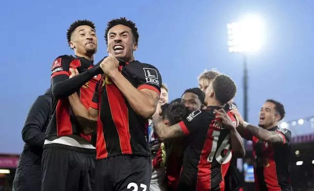 Bournemouth's James Hill, front, and his teammates celebrate winning on penalties during the FA Cup fifth round match between Wolverhampton and Bournemouth, Saturday, March 1, 2025, at the Vitality Stadium in Bournemouth, England. (Adam Davy/PA via AP)