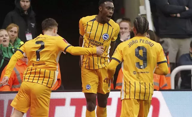 Brighton and Hove Albion's Danny Welbeck, centre, celebrates with teammates after scoring their side's second goal during the FA Cup fifth round match between Newcastle United and Brighton and Hove Albion at St James' Park, Newcastle, England, Sunday, March 2, 2025. (Owen Humphreys/PA via AP)