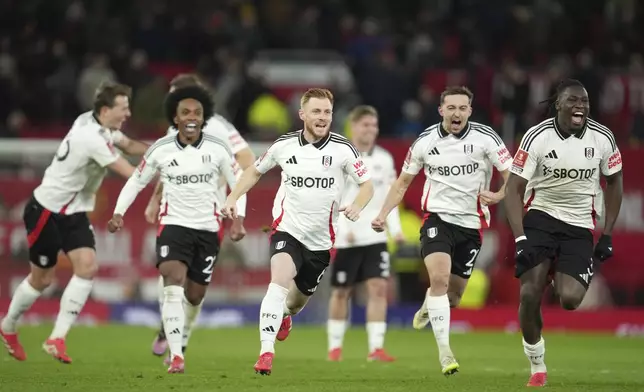 Fulham players celebrate after defeating Manchester United in a penalty shootout during the English FA Cup soccer match at the Old Trafford stadium in Manchester, England, Sunday, March 2, 2025. (AP Photo/Jon Super)