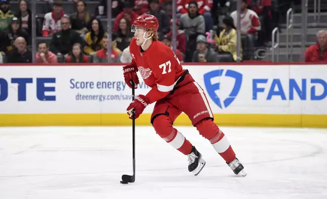 Detroit Red Wings defenseman Simon Edvinsson skates with the puck during the first period of an NHL hockey game against the Vegas Golden Knights, Sunday, March 16, 2025, in Detroit. (AP Photo/Jose Juarez)