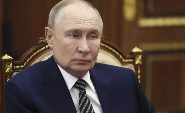 Russian President Vladimir Putin speaks with the governor of Arkhangelsk region Alexander Tsybulsky during their meeting at the Kremlin in Moscow, Russia, Tuesday, March 11, 2025. (Mikhail Metzel, Sputnik, Kremlin Pool Photo via AP)