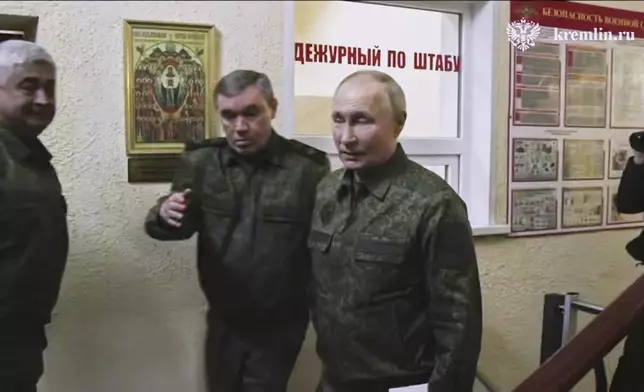 In this image made from video released by the Russian Presidential Press Service, on Wednesday, March 12, 2025, Russian President Vladimir Putin, right, accompanied by Russian Chief of General Staff Gen. Valery Gerasimov, second left, visits military headquarters in the Kursk region of Russia. (Russian Presidential Press Service via AP)
