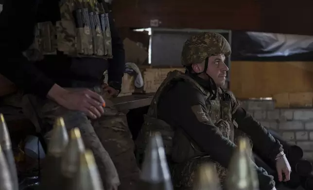 Ukrainian servicemen of Khartia brigade rest in the pause between firing towards Russian positions in Kharkiv region, Ukraine, Wednesday, March 12, 2025. (AP Photo/Alex Babenko)