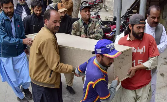 Rescue workers transport the coffin of a victim of the train attack, upon arrival at a hospital in Quetta, Pakistan's southwestern Balochistan province, Thursday March 13, 2025. (AP Photo/Arshad Butt)