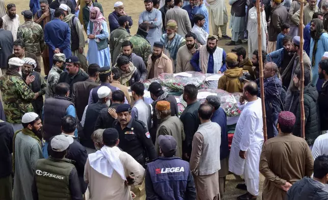 Mourners gather around a casket of a victim of the train attack, for a funeral prayer in Quetta, Pakistan's southwestern Balochistan province, Thursday March 13, 2025. (AP Photo/Arshad Butt)