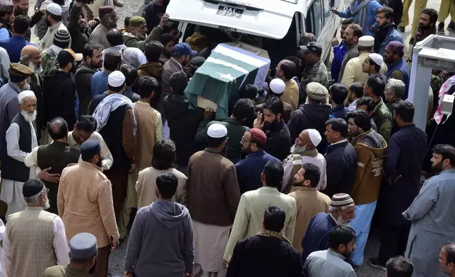 Mourners unload the casket of a victim of the train that was attacked by insurgents, for a funeral prayer in Quetta, Pakistan's southwestern Balochistan province, Thursday March 13, 2025. (AP Photo/Arshad Butt)
