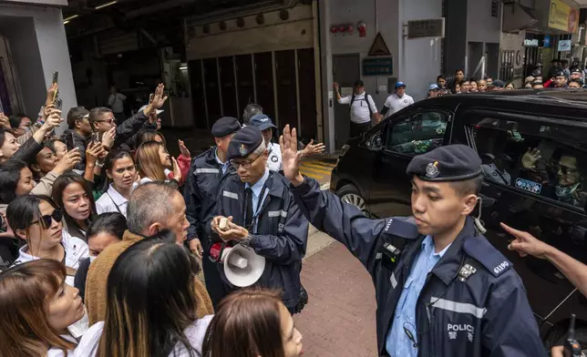 Supporters of former populist President of the Philippines Rodrigo Duterte waits for his arrival at a thanksgiving gathering organized by Hong Kong-based Filipino workers as Filipino actor, Robin Padilla arrives in a car in Hong Kong on Sunday, March 9, 2025. (AP Photo/Vernon Yuen)