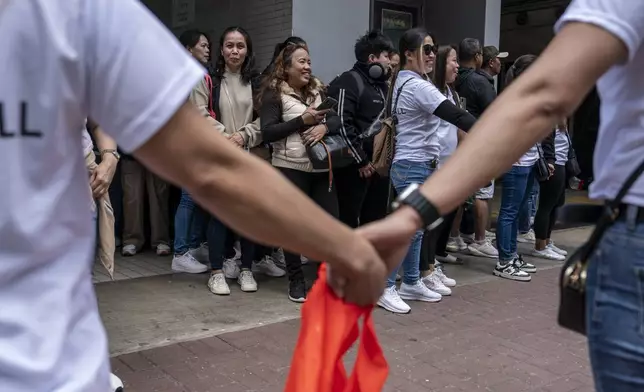Supporters of former populist President of the Philippines Rodrigo Duterte waits for his arrival at a thanksgiving gathering organized by Hong Kong-based Filipino workers in Hong Kong on Sunday, March 9, 2025. (AP Photo/Vernon Yuen)