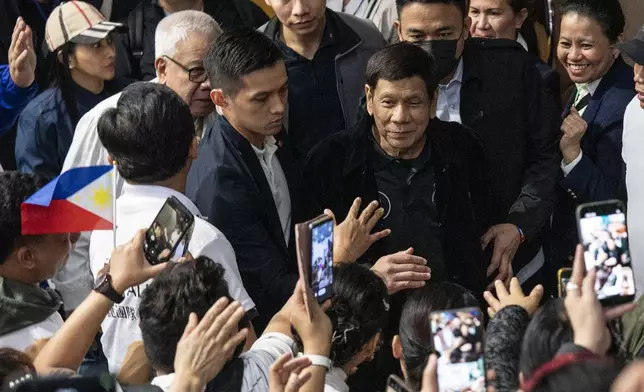 Former President of the Philippines Rodrigo Duterte arrives inside the Southorn Stadium during a thanksgiving gathering organized by Hong Kong-based Filipino workers for the former populist president in Hong Kong on Sunday, March 9, 2025. (AP Photo/Vernon Yuen)